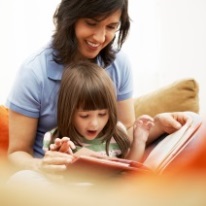 little girl and her mother reading a book