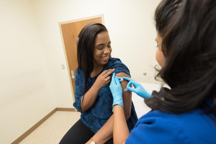 Black woman gets the vaccine.