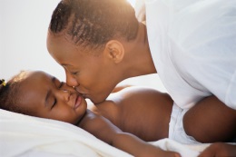 picture of a woman kissing a sleeping baby