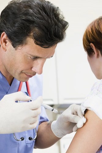 Doctor or nurse administering flu vaccination