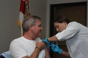 Dr. John Armstrong receiving a flu shot.