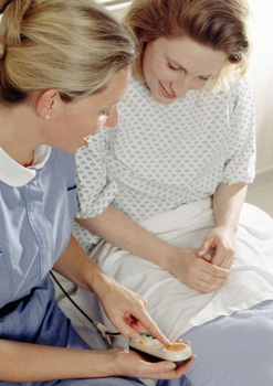 Healthcare provider showing a woman details of a medical testing procedure