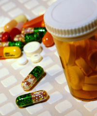 Various pills and a medication bottle