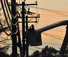 Silouette of workers working on powerlines