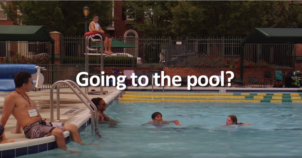 A family swimming in a community pool.