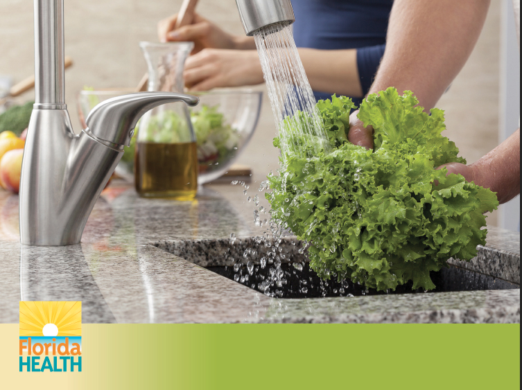 Image of person rinsing lettuce in sink.