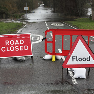 Flooding on roadway with signage