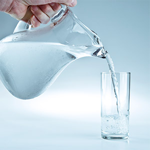 Water Pitcher pouring water into cup