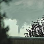Image of a tornado funnel dropping out of the sky