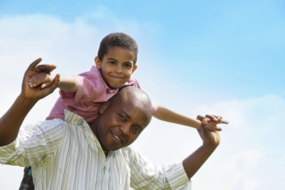 Father carrying his young son on his shoulders