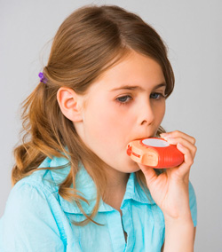 Girl taking asthma medicine