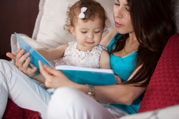 Mother reading to her young daughter