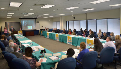 DOH and CDC Tuberculosis Partnership meeting photo. Image of attendees around the conference tables.