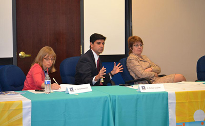 DOH and CDC Tuberculosis Partnership meeting photo. Image of 3 individuals at a conference table.