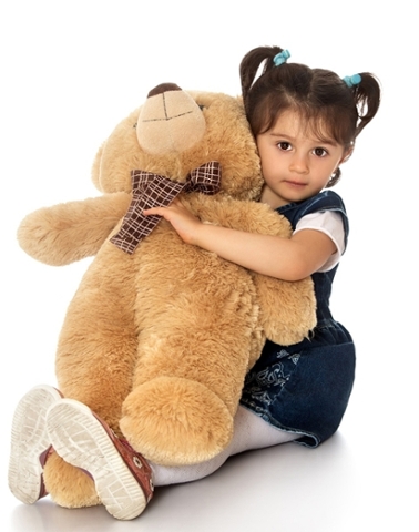 girl hugs teddy bear