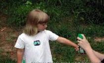 Adult applying repellant on a child