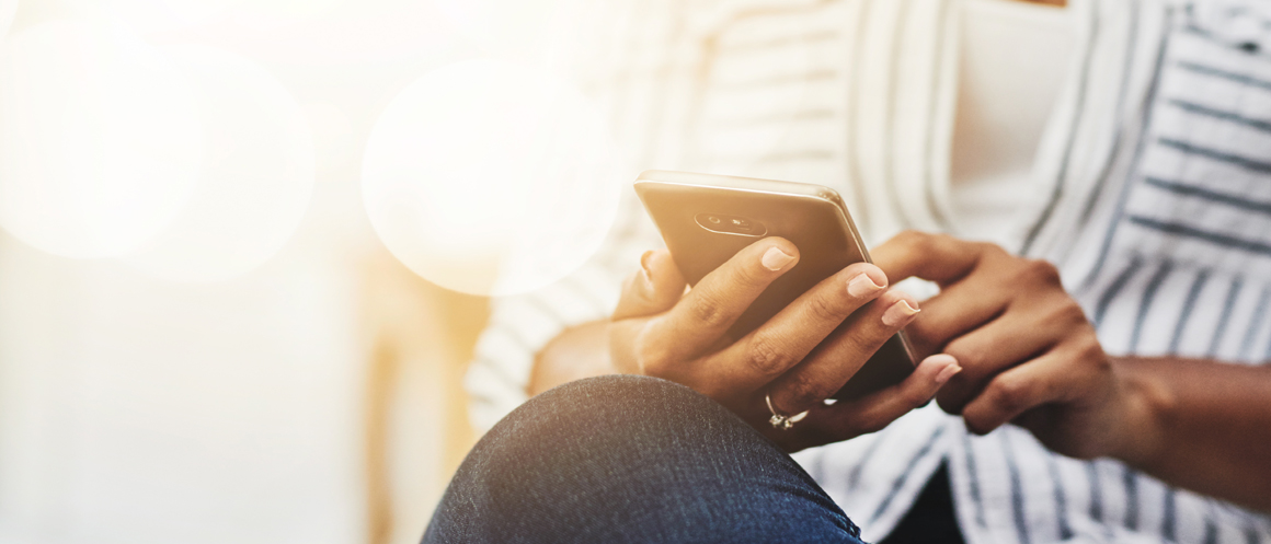 cropped image of a person tapping on a mobile phone