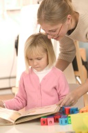 Mother reading a book with her daughter