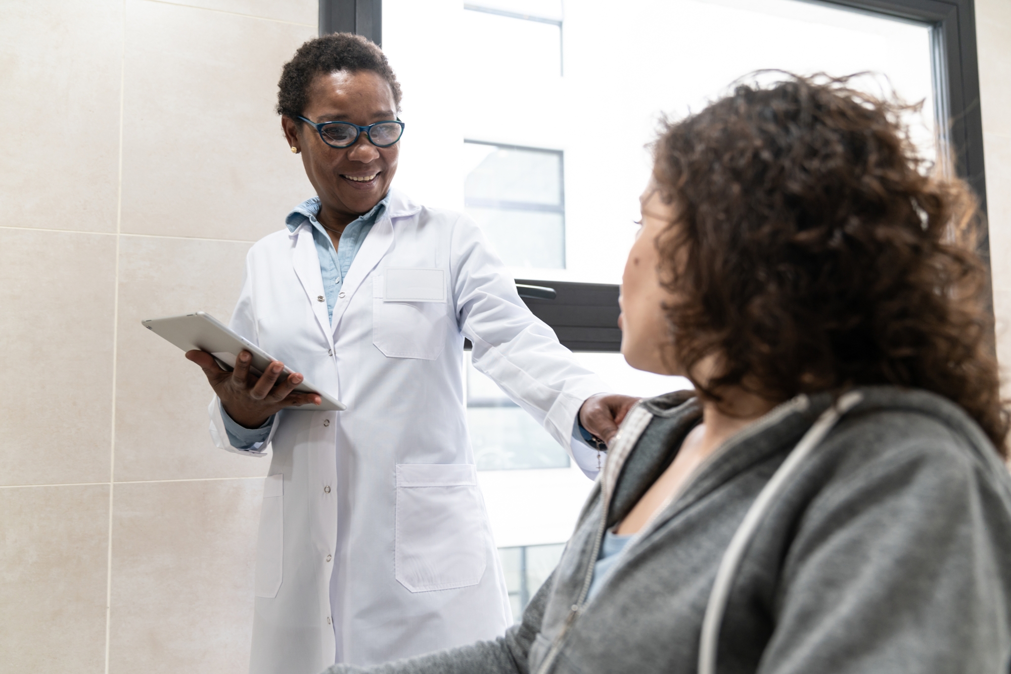 black doctor with patient