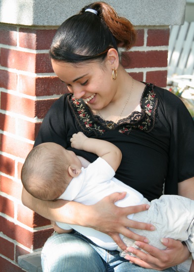 picture of a woman breastfeeding a baby outside