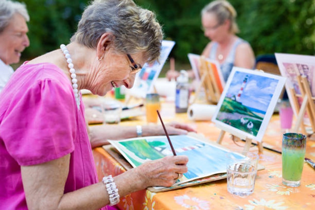 elderly people painting outside