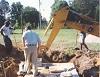 Contractor with septic tank and back hoe equipment
