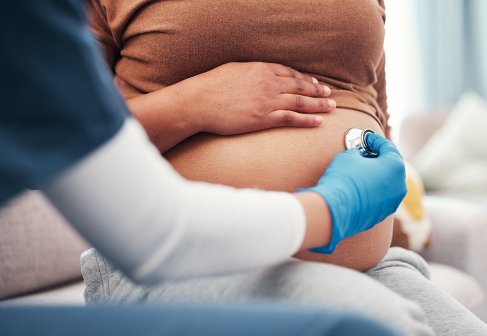 Pregnant woman being seen by her health care provider