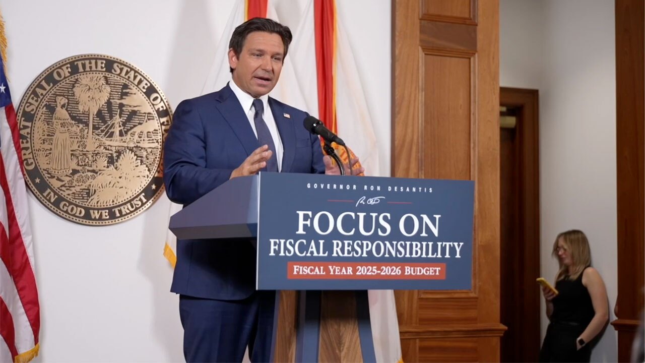 Governor Ron DeSantis speaking at a podium