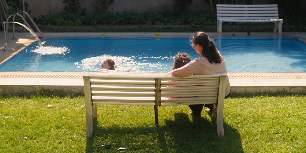 Woman supervising a child in a pool