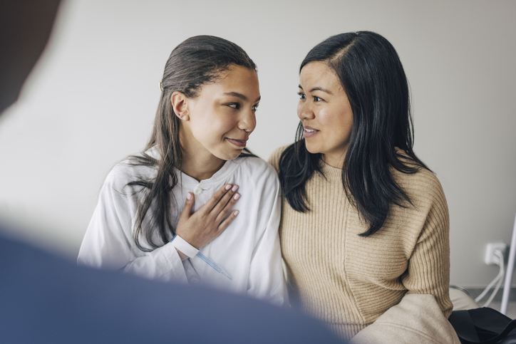 Teen with parent talking to doctor