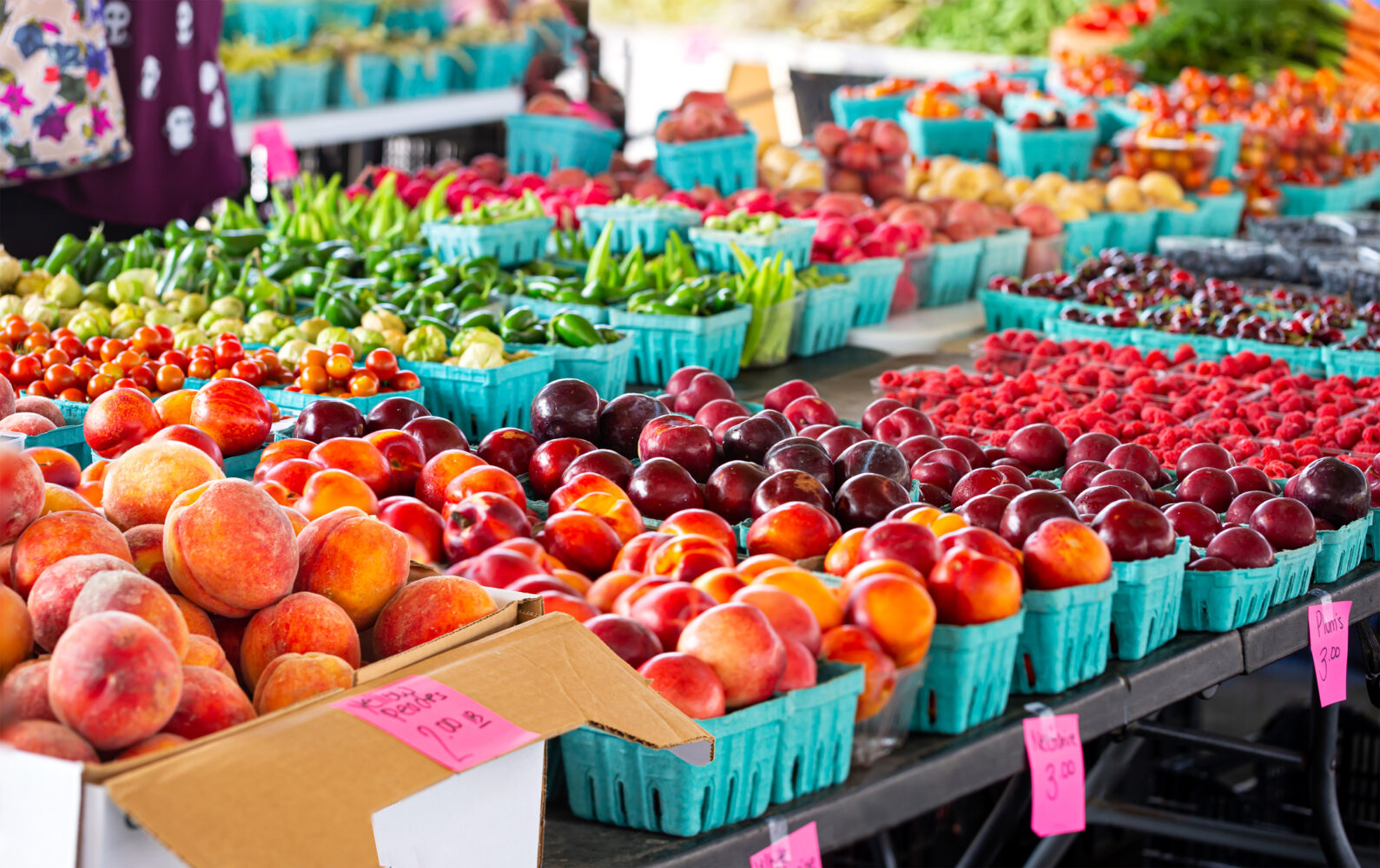 Farmers market table full of fruits and vegetables