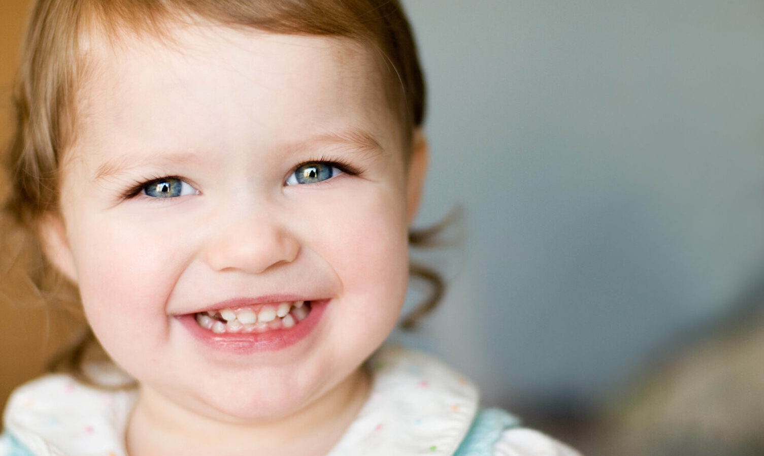 Toddler smiling showing clean white teeth