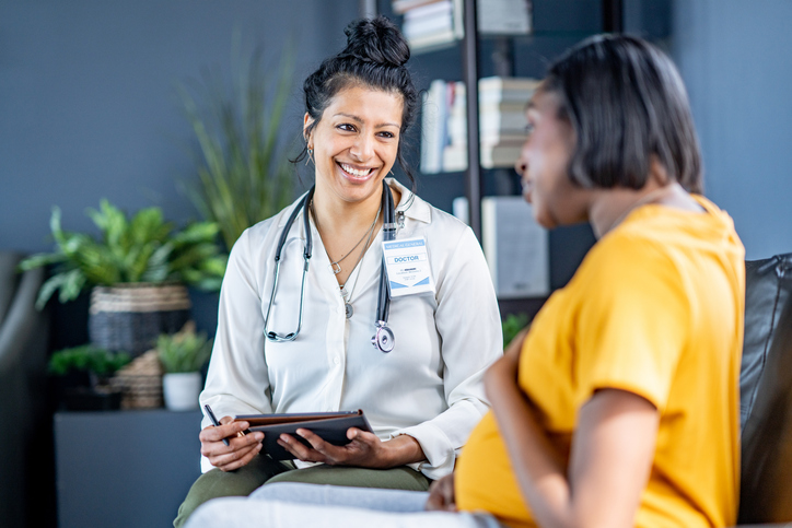 Health care provider talking to pregnant woman