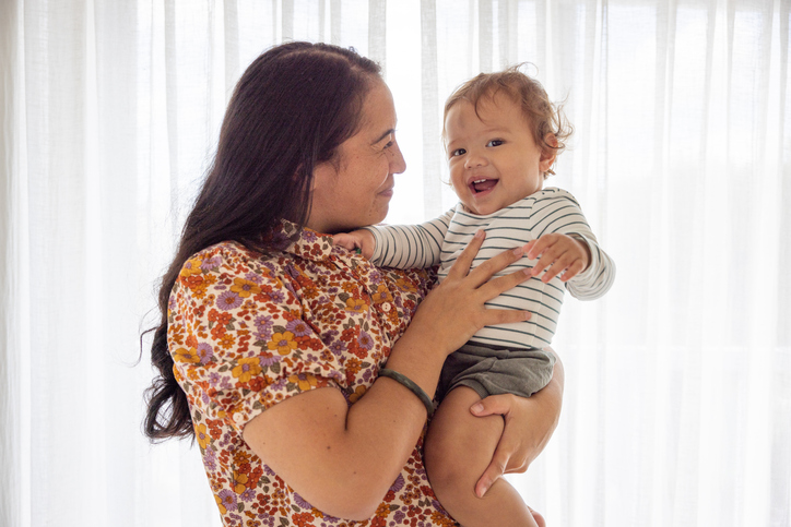 Mother holding happy infant