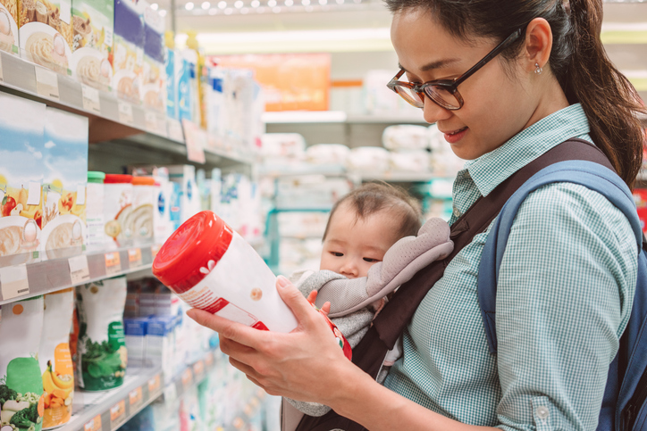 Young mother and infant in grocery store