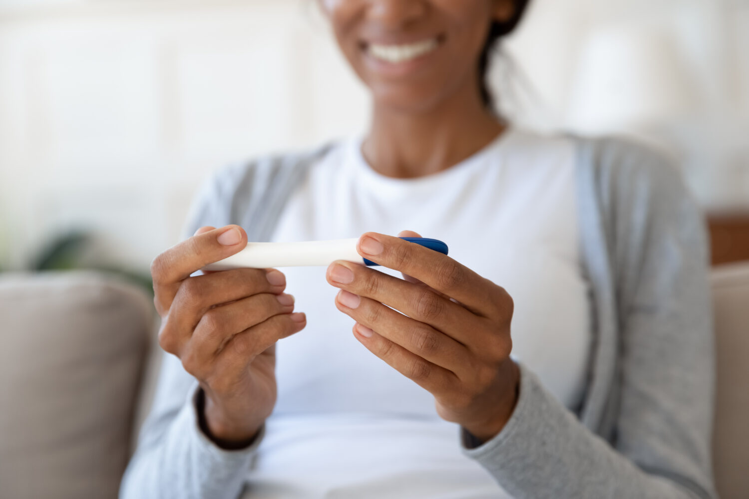 Close up of person with pregnancy test in hand