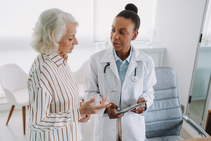 Older adult talking to a health care provider
