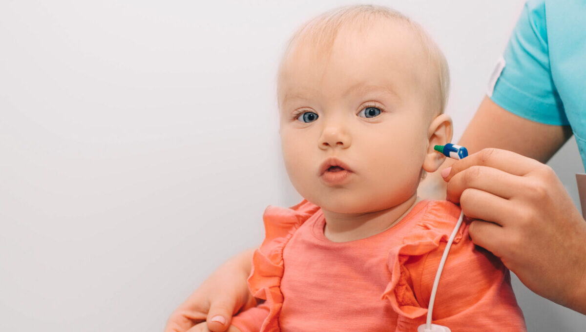 Medical provider checking baby's hearing