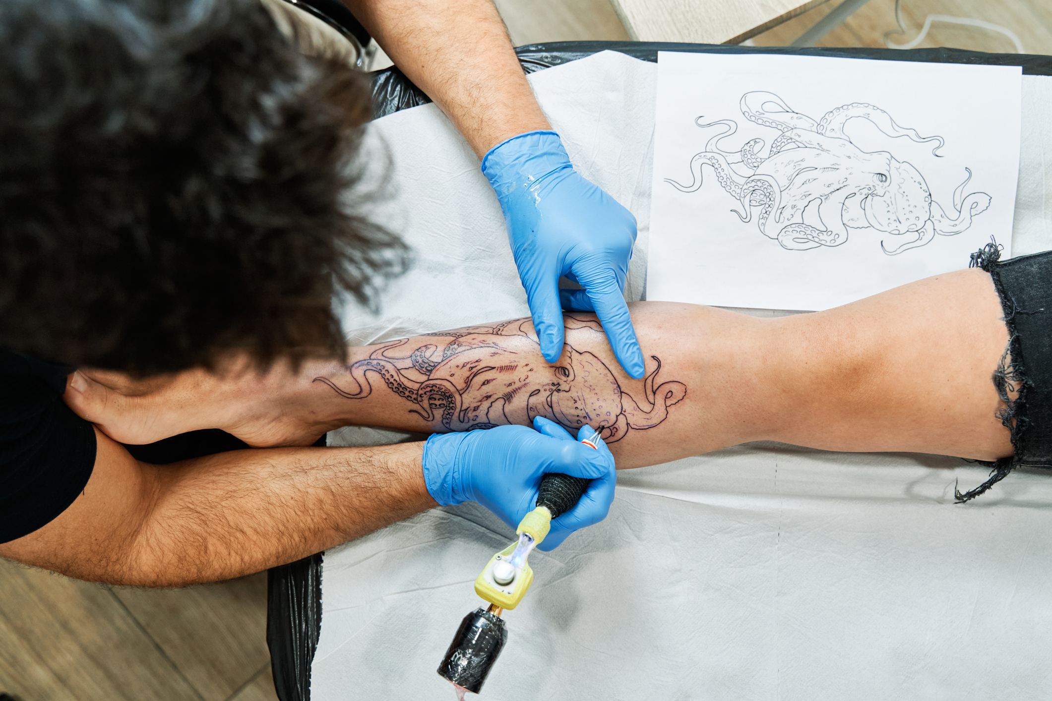 An overhead view of a tattoo artist