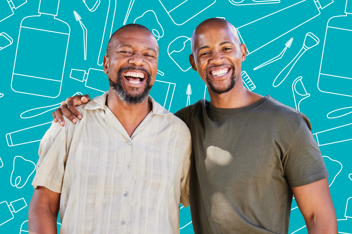 Father and son standing in front of dental hygiene products