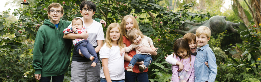 Group of children and teenagers, including two babies