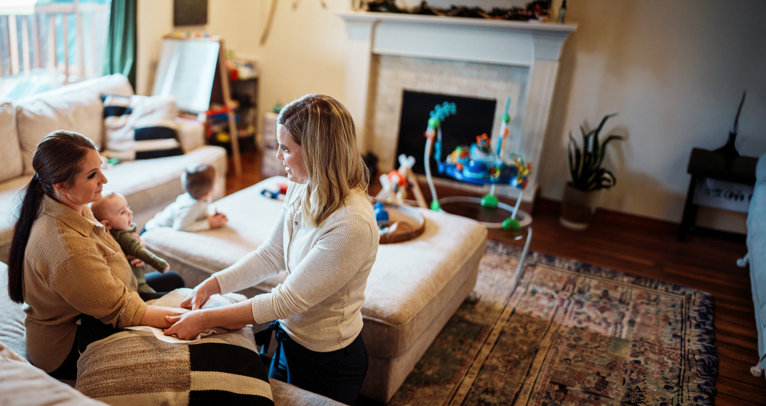 Postpartum mother gets assistance from women